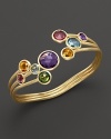 A rainbow of faceted semi-precious stones set in a flexible 18K yellow gold bangle. By Marco Bicego.