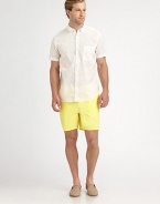 A vibrant summer essential, sport this garment dyed twill short with half-back elastic waist for added comfort.Flat-front styleSide slash, back welt pocketsInseam, about 6CottonMachine washMade in USA