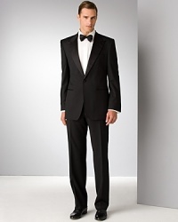 Hollywood style and elegance. Single-button front jacket with peak lapel and slit pocket. Decorative buttons. Inside pocket, fully lined. Trousers have hook and tab closure with zip fly. Satin detail on lapel and on side trim of pants. Lined to the knee. Unfinished hem. Hollywood style and elegance. Single-button front jacket with peak lapel and slit pocket. Decorative buttons. Inside pocket, fully lined. Trousers have hook and tab closure with zip fly. Satin detail on lapel and on side trim of pants. Lined to the knee. Unfinished hem.