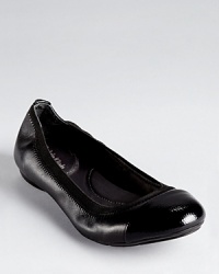 A lizard embossed cap toe lends an unexpected touch to Calvin Klein's Page flats, trimmed in elastic for flexible comfort. A lizard embossed cap toe lends an unexpected touch to Calvin Klein's Page flats, trimmed in elastic for flexible comfort.
