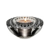 Embellished with intricately cut, angular facets that sparkle with reflected light, this votive candleholder from Orrefors adds an ornate element to the dining table.