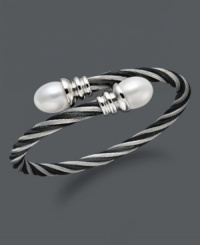 Wrap your wrists in polished perfection. This coil-shaped bangle bracelet features white cultured freshwater pearls (10-11 mm) set in twisted stainless steel. Approximate length: 8 inches.