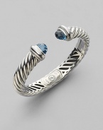 From the Waverly Collection. Cable twisted sterling silver with faceted blue topaz end caps.Blue topaz Sterling silver Width, about 10mm x 5mm Hinge closure Imported 