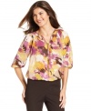 Let your style bloom this season in Ellen Tracy's floral-print blouse! It pairs perfectly with slim pants in a neutral color.