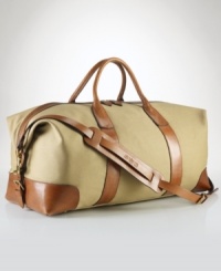 An ideal size for travel, this heritage duffle is rendered in durable cotton twill with glossy leather accents and a removable webbed shoulder strap for versatile on-the-go styling. An ideal size for travel, this heritage duffle is rendered in durable cotton twill with glossy leather accents and a removable webbed shoulder strap for versatile on-the-go styling.