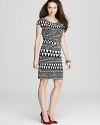 This slinky VINCE CAMUTO dress gets graphic with a mixed optic print and wide banded waist.