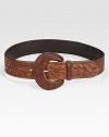 An oversized buckle and intricately designed leather give this belt rustic charm. About 2 wideLeatherImported