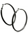 Luminous details take charge on these clutchless hoops from GUESS. Clear, black diamond, hematite and jet crystal stones adorn a classic earring silhouette. Crafted in hematite tone mixed metal. Approximate drop: 2-1/4 inches.