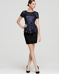 Ali Ro's smart and sparkling dress exudes elegance in a peplum silhouette, detailed with a bow belt for a feminine finish. Ali Ro's smart and sparkling dress exudes elegance in a peplum silhouette, detailed with a bow belt for a feminine finish.
