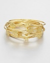 Stacked set of ten bangles with goldplated logo medallions for a simple, layered look. 16K goldplated brassDiameter, about 2½Slip-on styleImported