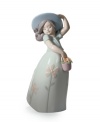 Lladro captures the innocence of youth in the Little Daisy figurine. A young lady twirls about, carrying a basket of flowers and happy to enjoy a spring day