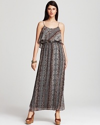 Work the safari trend into your daily repertoire with this Karen Kane maxi dress, boasting a graphic mix of tribal and animal prints. A ruffled bodice finishes the style with untamed femininity. Work the safari trend into your daily repertoire with this Karen Kane maxi dress, boasting a graphic mix of tribal and animal prints. A ruffled bodice finishes the style with untamed femininity.