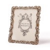 A rich frame of cast pewter in an antique brass finish with dozens of hand-set Swarovski® crystals, tiger's eye, and faux pearls make this a dazzling display for your favorite photos.