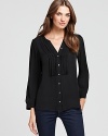 You'll adore the details on this Joie silk top--from the ruffled front to the pleating at the shoulders to the mother of pear buttons. Dress it up with fitted black work trousers or wear it with your favorite pair of jeans.