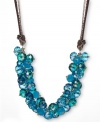 Shimmering blues liven up your look. This c.A.K.e. by Ali Khan necklace features turquoise-colored glass bead clusters (10-12 mm) with a brown suede and gold tone mixed metal setting. Approximate length: 18 inches + 3-inch extender. Approximate drop: 4-1/4 inches.