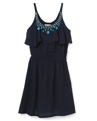 A design trip to Santa Fe inspired this one-of-a-kind Sally Miller dress that flaunts a turquoise stone-embellished neckline with subtle ruffle details below. A design trip to Santa Fe inspired this one-of-a-kind Sally Miller dress that flaunts a turquoise stone-embellished neckline with subtle ruffle details below.