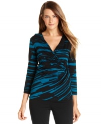A feather-inspired print adorns this faux-wrap style top from Calvin Klein, sure to add a fashionable flourish to a pair of black pants or a pencil skirt. A feather-inspired print adorns this faux-wrap style top from Calvin Klein, sure to add a fashionable flourish to a pair of black pants or a pencil skirt.