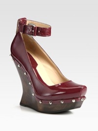 A sculptural wooden heel lifts this studded patent leather design, topped with a trendy-worthy ankle strap. Wooden wedge, 5 (125mm)Wooden platform, 1 (25mm)Compares to a 4 heel (100mm)Patent leather upper with metal studsAdjustable ankle strapLeather liningRubber solePadded insoleImportedOUR FIT MODEL RECOMMENDS ordering one half size up as this style runs small. A sculptural wooden heel lifts this studded patent leather design, topped with a trendy-worthy ankle strap. Wooden wedge, 5 (125mm)Wooden platform, 1 (25mm)Compares to a 4 heel (100mm)Patent leather upper with metal studsAdjustable ankle strapLeather liningRubber solePadded insoleImportedOUR FIT MODEL RECOMMENDS ordering one half size up as this style runs small.
