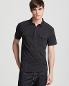 A unique polo from John Varvatos Star USA features a pair of chest pockets with buttons and allover mottled effect for modern appeal.