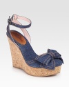 Secured by an adjustable ankle strap, this stretchy denim style is updated by a bow-adorned closed toe and cork wedge. Cork wedge, 5Cork platform, 2Compares to a 2 heelDenim upperDenim liningLeather solePadded insoleMade in ItalyOUR FIT MODEL RECOMMENDS ordering one half size up as this style runs small. 