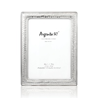 A croc-inspired texture makes this timeless and refined sterling silver frame a chic must-have. Use it to frame your favorite photos, to display a special invitation or for special gifting occasions. A croc-inspired texture makes this timeless and refined sterling silver frame a chic must-have. Use it to frame your favorite photos, to display a special invitation or for special gifting occasions.