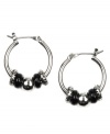 These mini hoops make a stylish impact. Nine West design features a shiny hoop setting that highlights bold, plastic jet beads. Crafted in silver tone mixed metal. Approximate diameter: 5/8 inch.