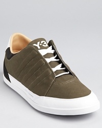 Adidas' Y-3 series continues to mine super modern looks. This low-top sneaker sports extended side panels and tonal, raised log stripes. Adidas' Y-3 series continues to mine super modern looks. This low-top sneaker sports extended side panels and tonal, raised log stripes.