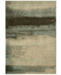 Abstract and dramatic, this handcrafted wool rug features a rich spectrum of shades from sky tones to deep smoke. The ethereal coloration pattern is reminiscent of a soothing lake set in watercolors. An exclusive luster-wash finish gives the rug a beautiful, subtle finish. Abstract and dramatic, this handcrafted wool rug features a rich spectrum of shades from sky tones to deep smoke. The ethereal coloration pattern is reminiscent of a soothing lake set in watercolors. An exclusive luster-wash finish gives the rug a beautiful, subtle finish.