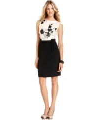 A painterly floral print adorns the bodice of this Tahari by ASL dress, set to perfectly contrast with the solid skirt. A ruffled, foldover detail at the left hip provides dramatic definition. A painterly floral print adorns the bodice of this Tahari by ASL dress, set to perfectly contrast with the solid skirt. A ruffled, foldover detail at the left hip provides dramatic definition.