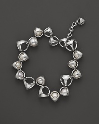 A bold sterling silver bracelet, gleaming with freshwater pearls, is an elegant showcase for Di MODOLO's iconic Triadra design. A bold sterling silver bracelet, gleaming with freshwater pearls, is an elegant showcase for Di MODOLO's iconic Triadra design.
