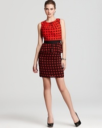 Dotted octagons lend a geometric-meets-ladylike look to Trina Turk's printed dress--a peplum silhouette completes this feminine look. Dotted octagons lend a geometric-meets-ladylike look to Trina Turk's printed dress--a peplum silhouette completes this feminine look.