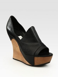 Low-cut pebbled leather upper engulfs a natural wooden wedge and platform. Wooden and leather wedge, 5 (125mm)Wooden platform, 1½ (40mm)Compares to a 3½ heel (90mm)Leather upperLeather liningRubber solePadded insoleImportedOUR FIT MODEL RECOMMENDS ordering one half size up as this style runs small. Low-cut pebbled leather upper engulfs a natural wooden wedge and platform. Wooden and leather wedge, 5 (125mm)Wooden platform, 1½ (40mm)Compares to a 3½ heel (90mm)Leather upperLeather liningRubber solePadded insoleImportedOUR FIT MODEL RECOMMENDS ordering one half size up as this style runs small.