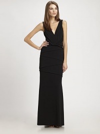 Flattering draping and architectural tucks elevate this elegant, evening-perfect design.Surplice necklineSleevelessTwist-front detailSkirt tucksSlight trainV back with concealed zipAbout 48 from natural waist68% acetate/27% polyester/5% spandexDry cleanMade in USA of imported fabricModel shown is 5'11 (180cm) wearing US size 4. Flattering draping and architectural tucks elevate this elegant, evening-perfect design.Surplice necklineSleevelessTwist-front detailSkirt tucksSlight trainV back with concealed zipAbout 48 from natural waist68% acetate/27% polyester/5% spandexDry cleanMade in USA of imported fabricModel shown is 5'11 (180cm) wearing US size 4.
