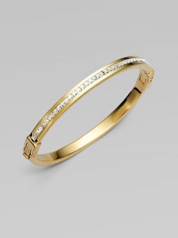 A narrow design that sparkles with a row of dazzling clear rhinestones. RhinestonesGoldtone steelDiameter, about 2¾Hinged, push lock closureImported 