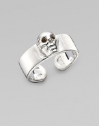 A thick adjustable band with a single prominent skull at the center. Sterling silver Width, about ¾ Made in Italy 