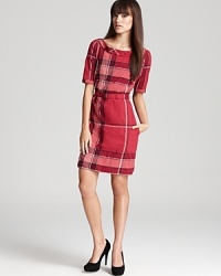 A contemporary take on classic plaid, this Burberry Brit dress goes bold with an oversized check print and statement hardware for a pretty-in-punk look.