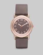 Smart and chic style with leather strap. Quartz movement Water resistant to 5 ATM Round ion-plated rose gold stainless steel case, 33mm (1.3) Gray mirror logo dial Second hand Metallic gray leather strap, 18mm wide (0.7) Imported 