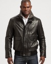 This classic bomber style is perfect for any occasion, shaped in supple leather with a removable genuine dyed shearling collar for the ultimate experience of warmth and comfort.Zip frontButtoned placketWaist flap pocketsRibbed knit hemFully linedAbout 27 from shoulder to hem LeatherDry cleanImportedFur origin: Portugal