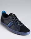 Suede and leather combine in alternating panels for an intriguing take on the everyday sneaker by Paul Smith.