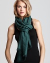 A jacquard pattern of iconic Ts gives a beautiful touch to this merino wool Tory Burch scarf.