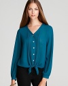 Feeling blue never looked so beautiful thanks to this pretty pleated blouse we adore.