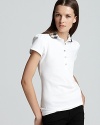 Ruched detail on the collar and puffed sleeves lend a feminine touch to the classic polo.