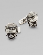 A dimensional recreation of Mary Shelly's timeless character peeks out from a suit or blazer in polished sterling silver. Garnet eyes About 1 diam. Imported