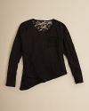 A boxey dolman sleeve tee is updated with a lacy chest pocket and dramatic diagonal hemline.