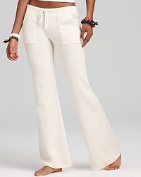 A trend-right flared leg and pocket detail updates the classic silhouette of these Juicy Couture velour pants. A trend-right flared leg and pocket detail updates the classic silhouette of these Juicy Couture velour pants.