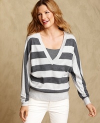 A deep V-neckline adds a sultry touch to Tommy Hilfiger's casual striped sweater. Layer it with a cami and jeans for essential everyday style. A deep V-neckline adds a sultry touch to Tommy Hilfiger's casual striped sweater. Layer it with a cami and jeans for essential everyday style.