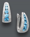 Traditional hoops in bold, blue hues. Classic J-hoop earrings receive a sparkling touch with round-cut blue topaz (1-1/2 ct. t.w.), round-cut diamonds (1/10 ct. t.w.), and a polished sterling silver setting. Approximate diameter: 1/2 inch.