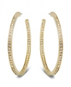 Star-studded style. This elegant pair of gold tone hoop earrings sparkles in clear Swarovski crystal pavé, reflecting the light beautifully and adding a touch of sophistication to any outfit. Approximate diameter: 1-7/8 inches.