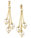 Start your date night with confidence with these elegant drop earrings by Anne Klein. Three cream-colored plastic pearls are suspended from glass stone-accented posts. Crafted in gold tone mixed metal. Approximate drop: 2 inches.
