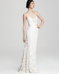 The epitome of modern romance, this Theia silk gown boasts a graceful cascade of delicate petals.